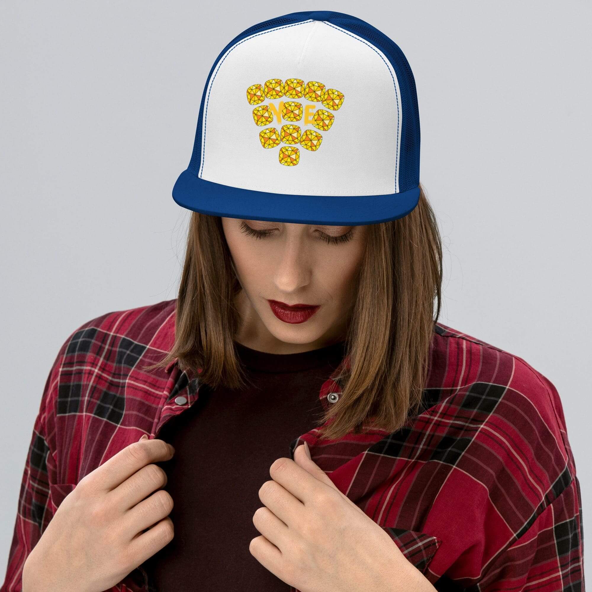 Woman wearing cap with yellow emoji design.