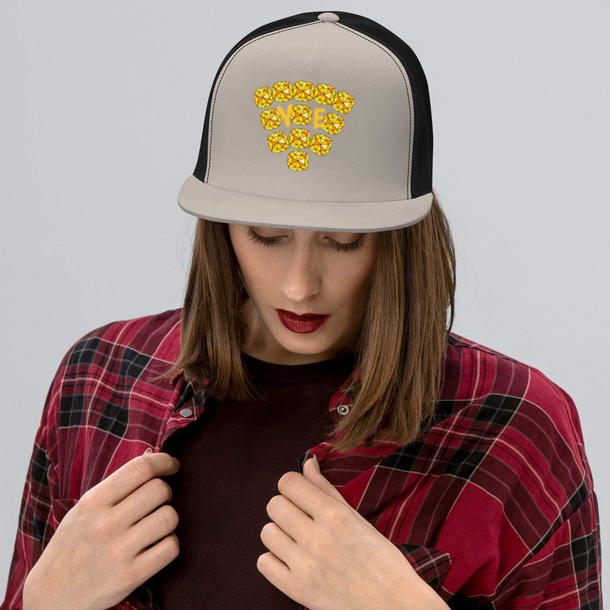 Woman wearing D.A.D.D. cap and plaid shirt.