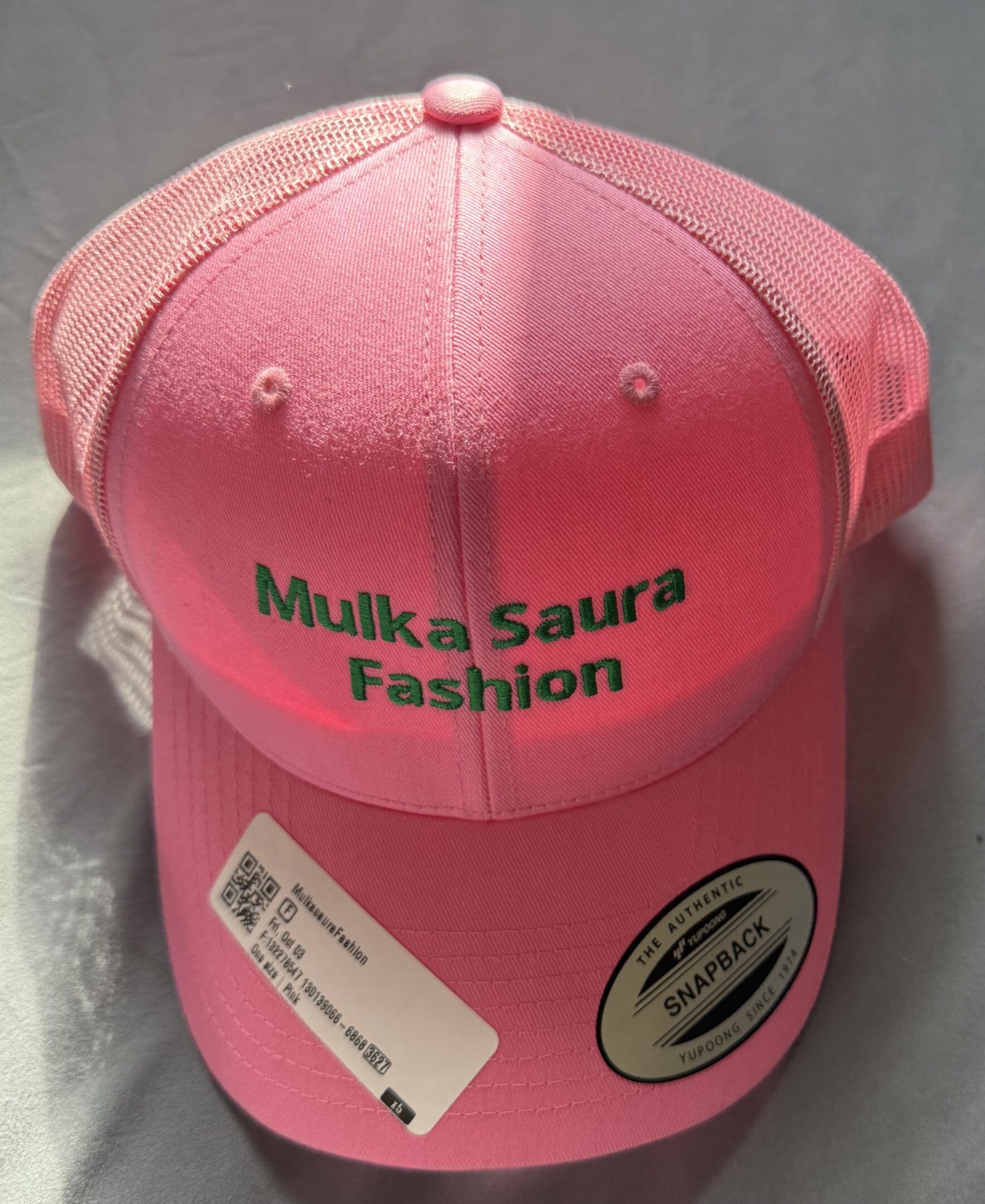 Pink cap with "Mulka Saura Fashion" text.