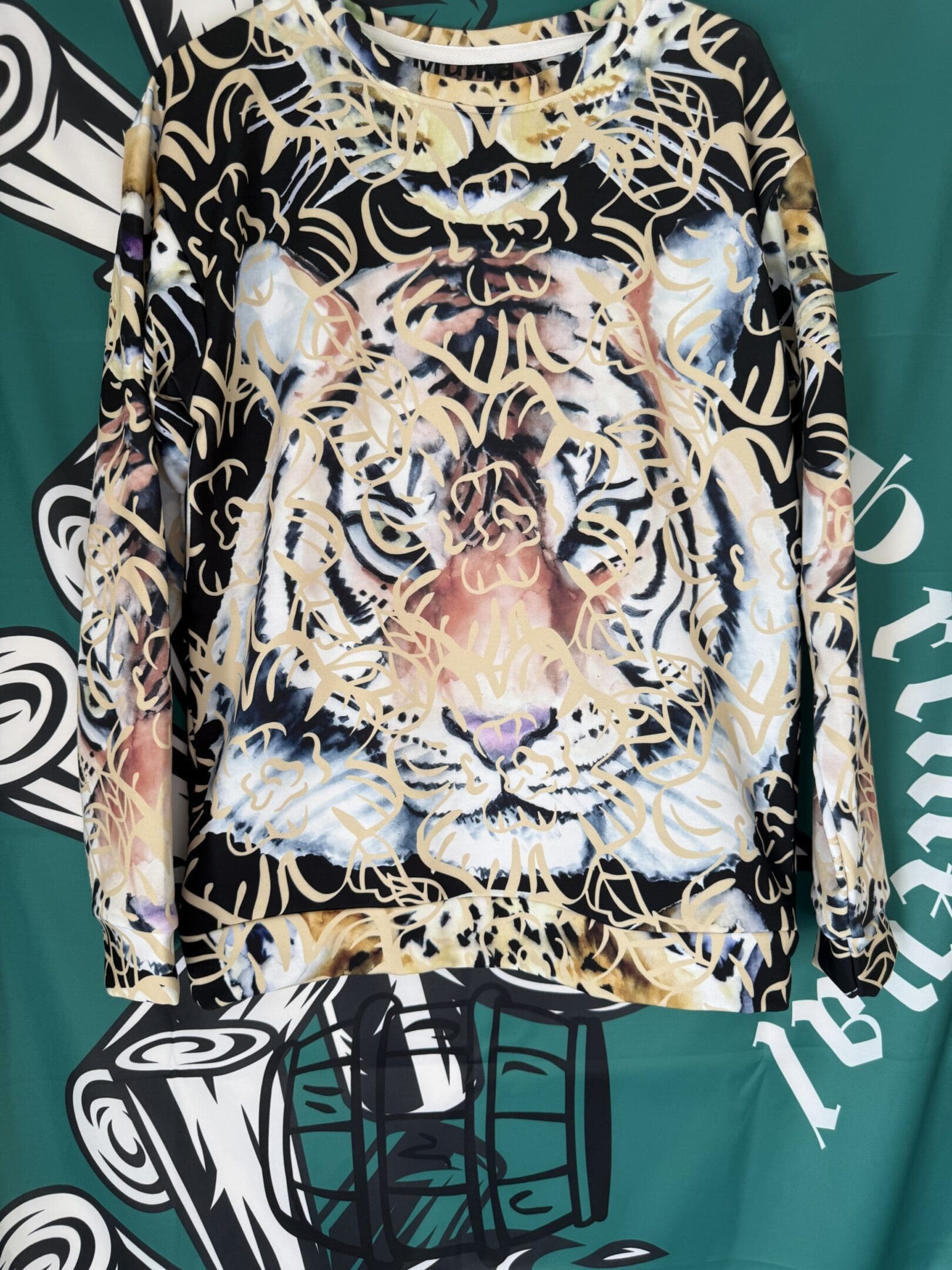 Tiger face graphic on a colorful shirt.