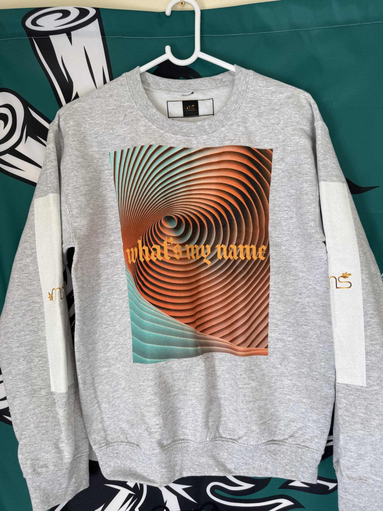 Gray sweatshirt with abstract spiral design.