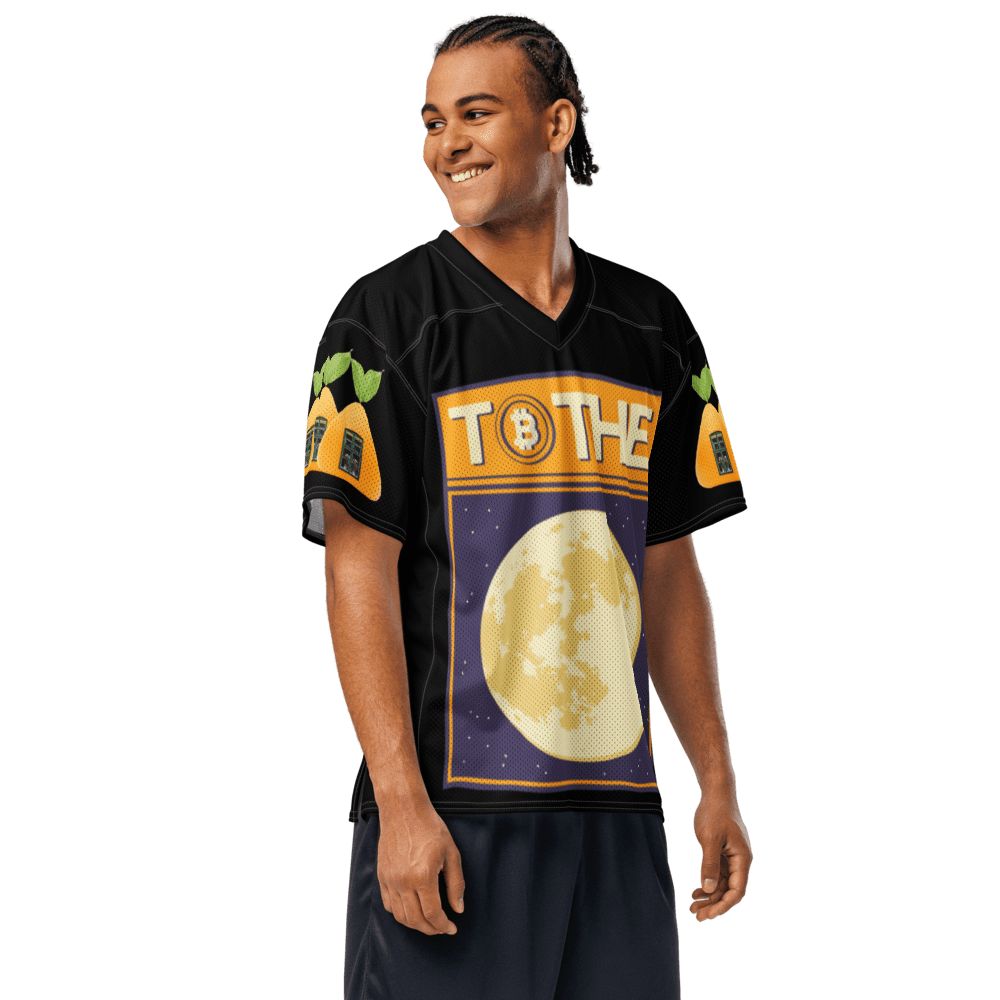 Man wearing a themed football jersey, smiling.