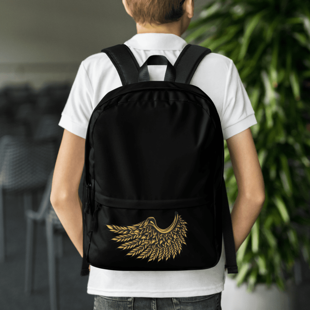 Boy wearing black backpack with wing design.