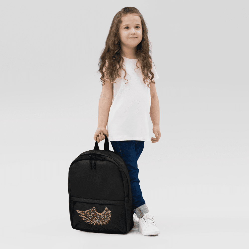 Child holding a black backpack with wings.