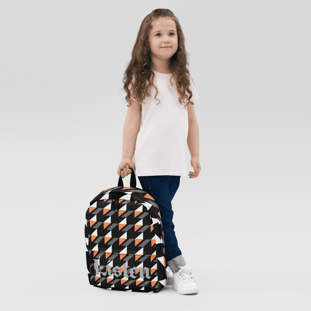 Child with patterned backpack, standing confidently.