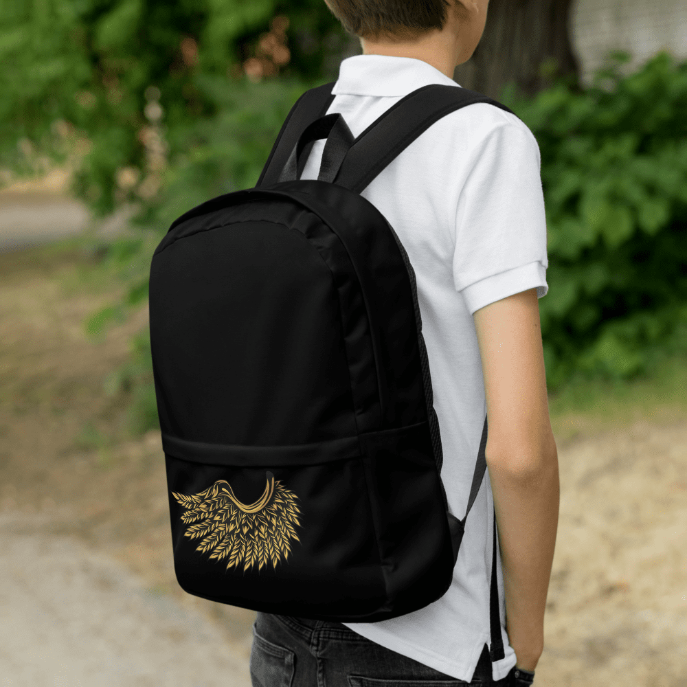 Person wearing backpack with golden wing design.