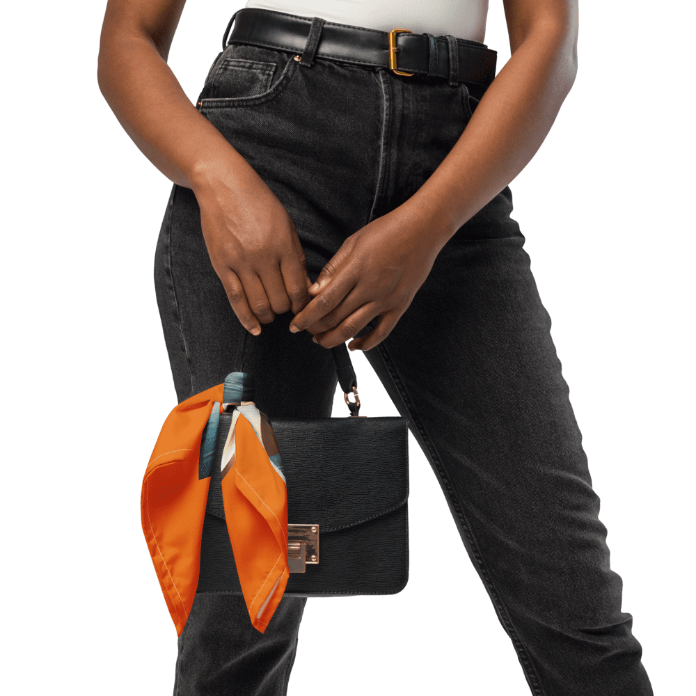 Person holding purse with orange scarf.
