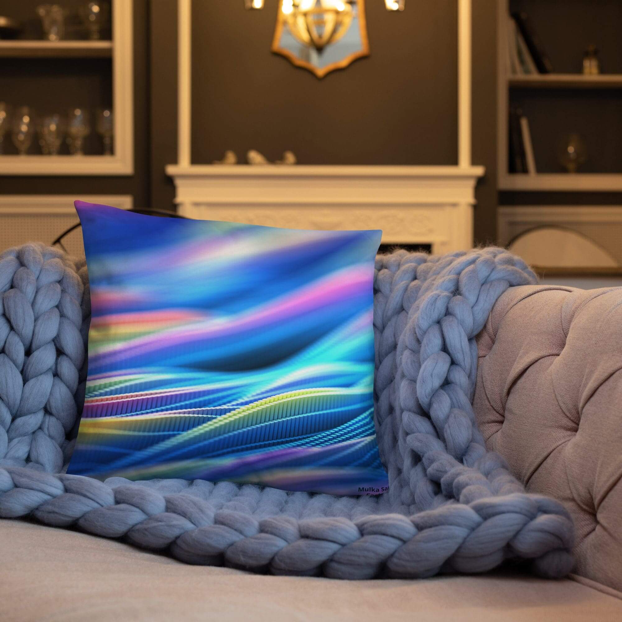 Colorful pillow on a cozy knitted blanket.