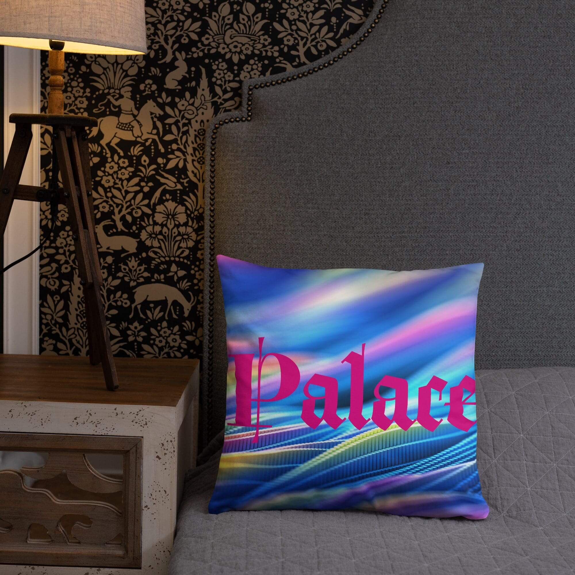 Decorative pillow on bed near lamp.