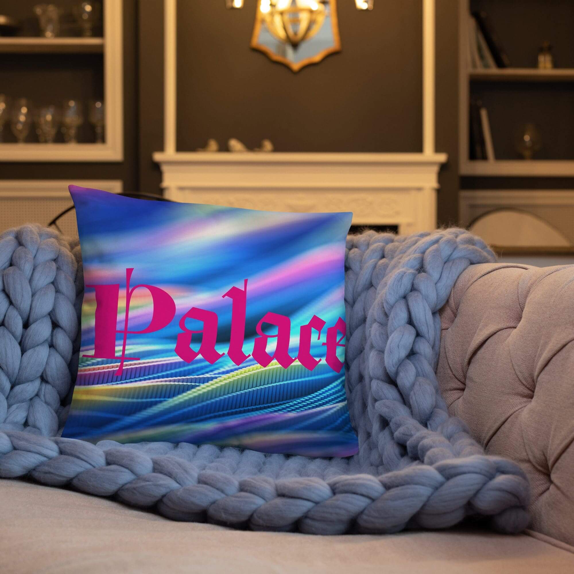 Couch with colorful "Palace" pillow and blanket.