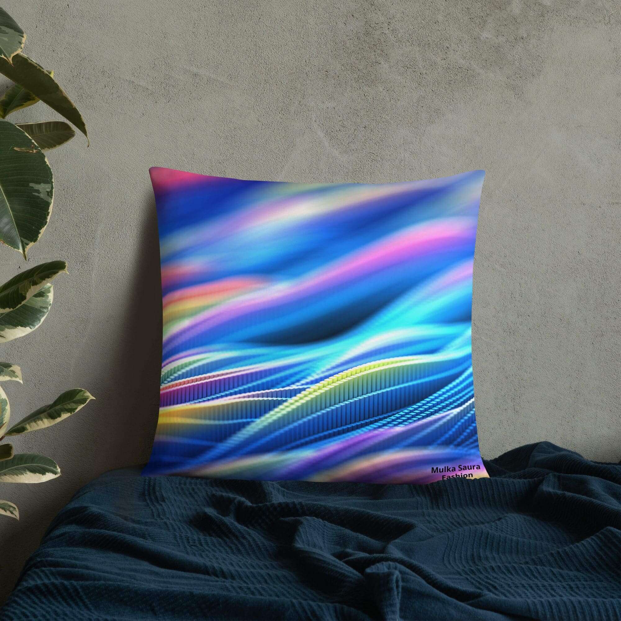 Colorful abstract pillow on blue bedspread.