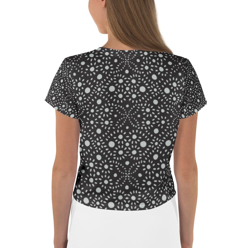 Woman wearing black patterned short-sleeve top.