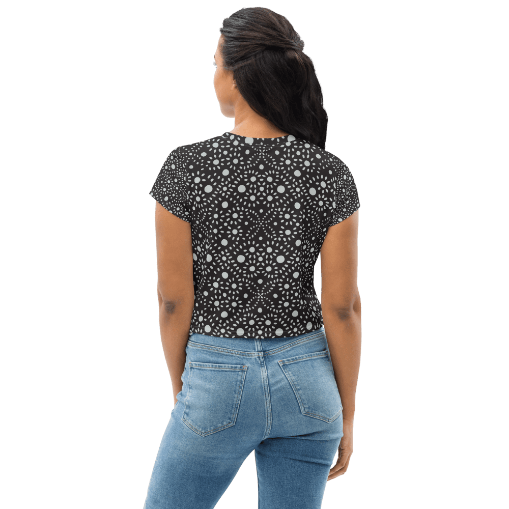 Woman in patterned shirt and jeans, back view.