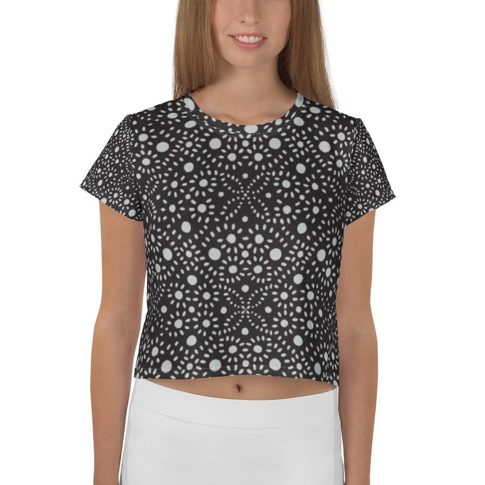 Woman wearing black and white patterned top.