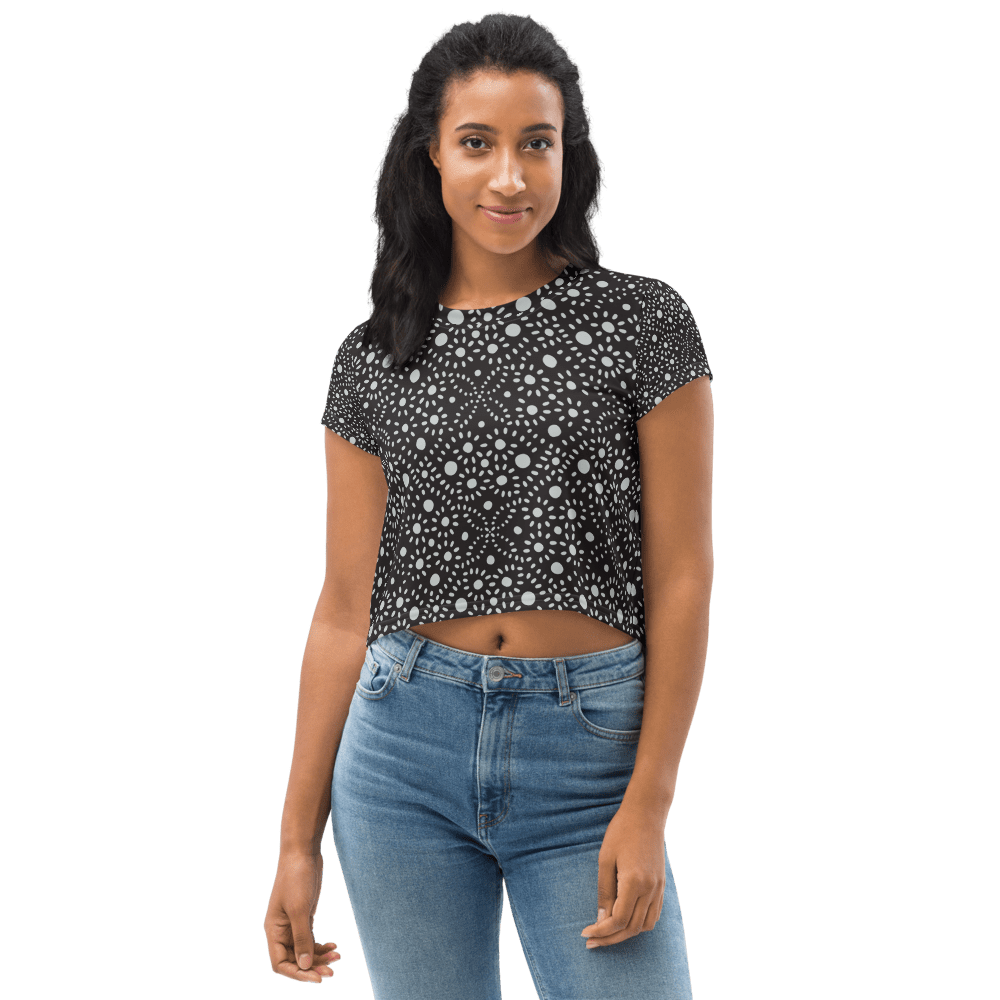 Woman in patterned crop top and jeans.