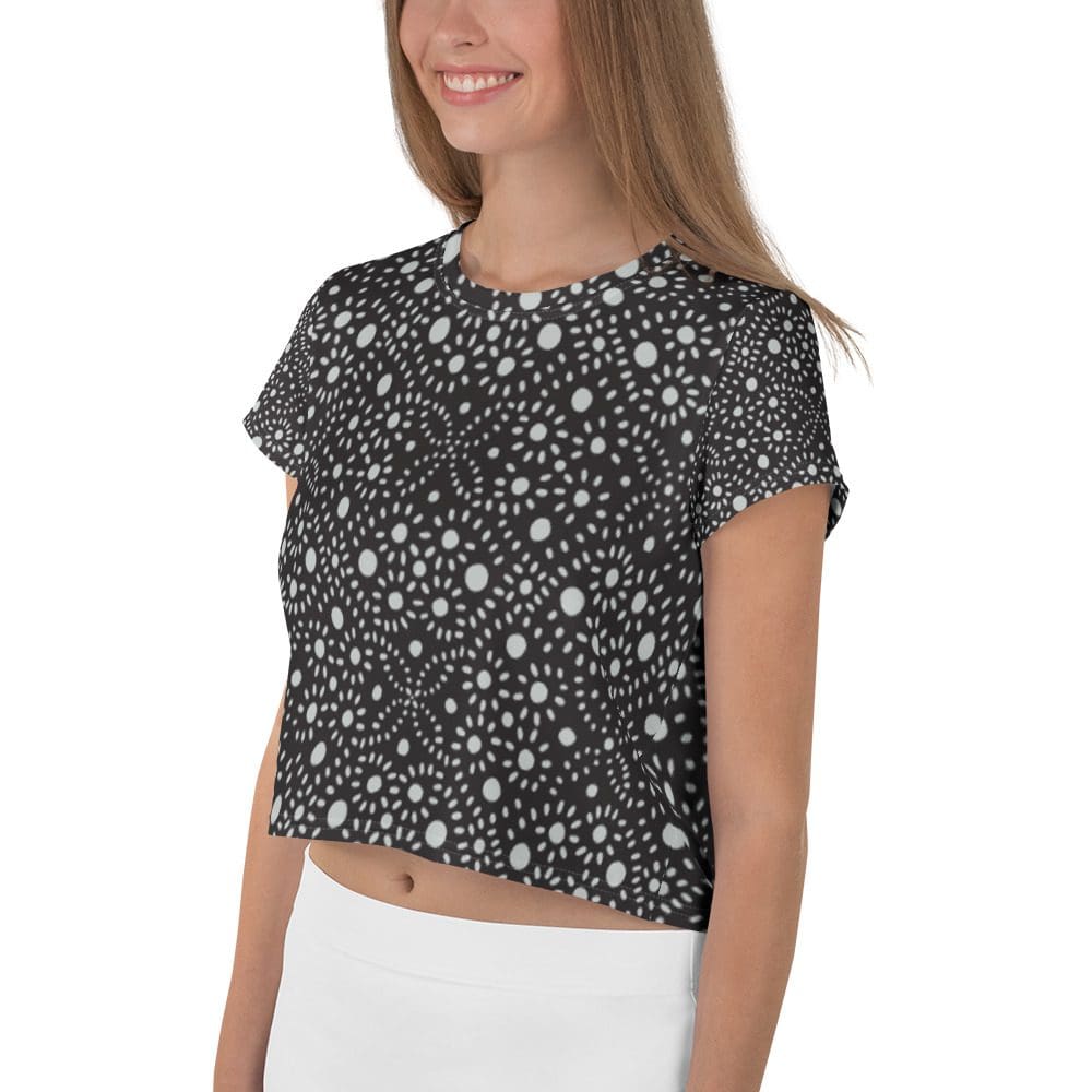 Smiling woman wearing patterned black crop top.