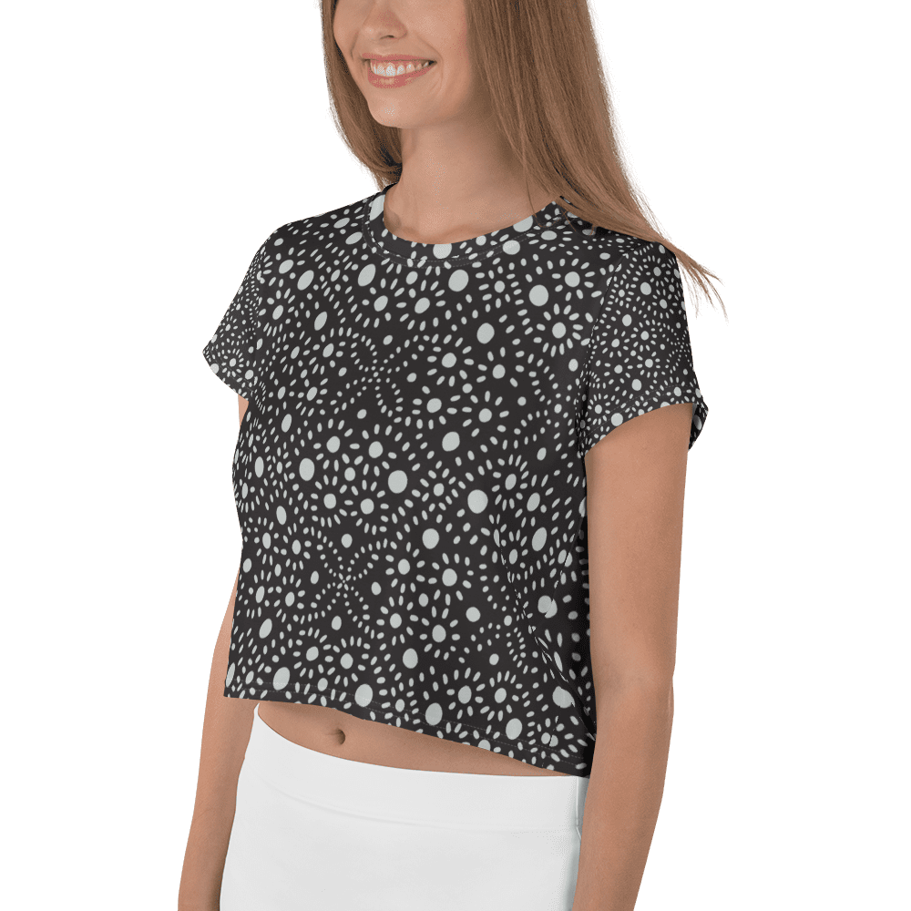 Woman wearing black patterned crop top.