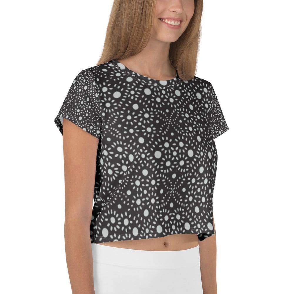 Woman wearing black and white patterned crop top.