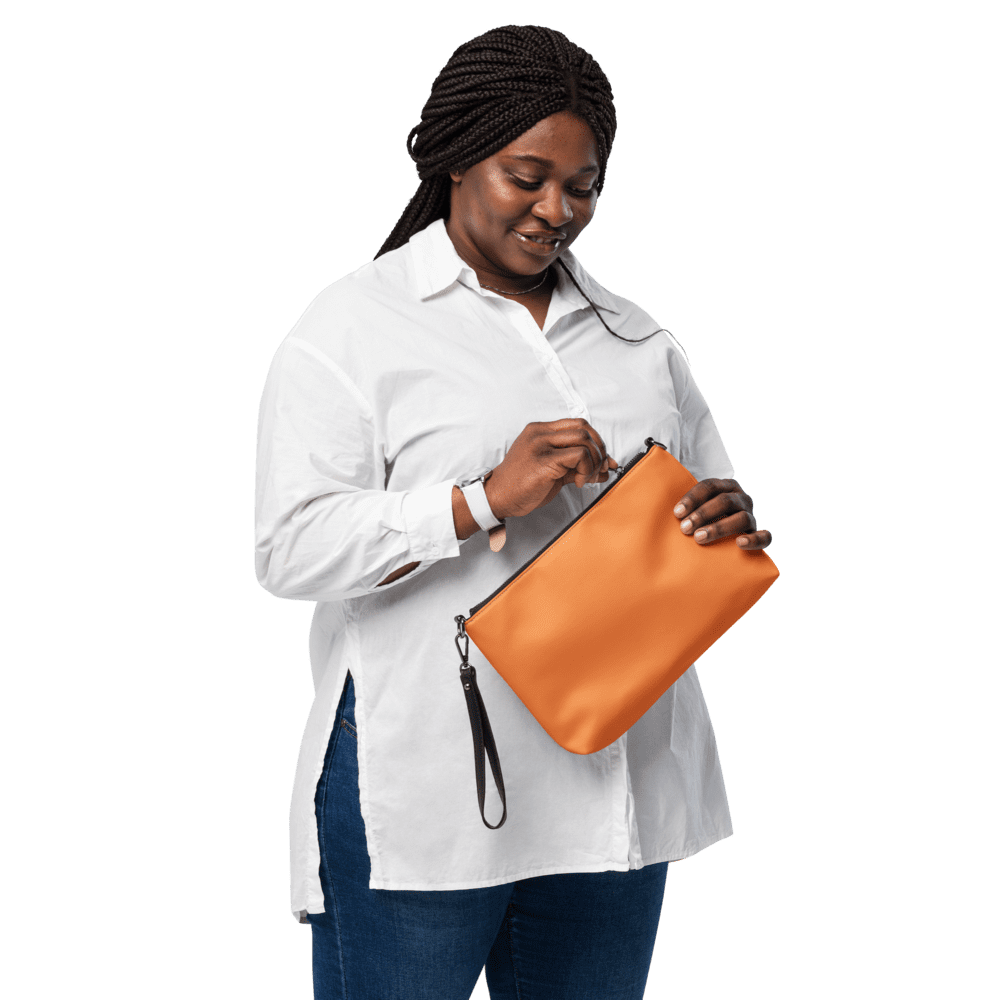 Woman holding an orange clutch bag.