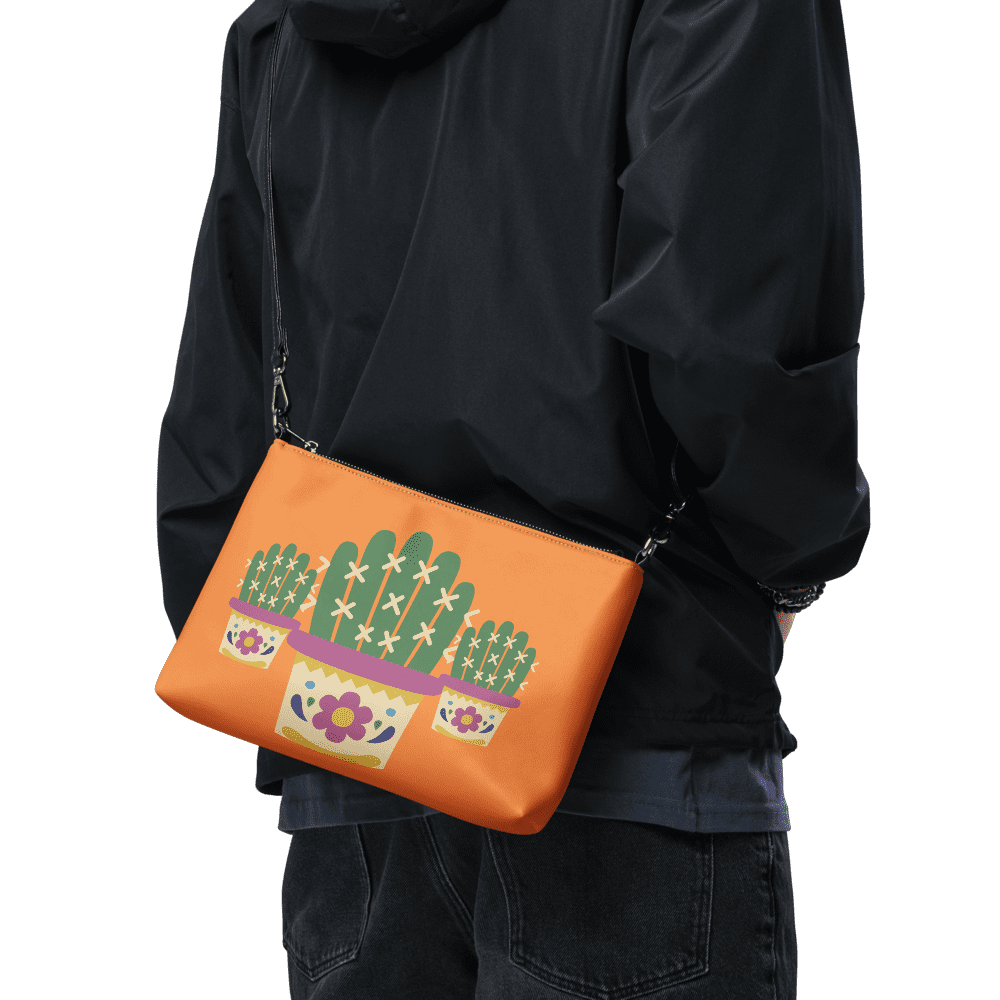 Person wearing cactus-themed orange crossbody bag.