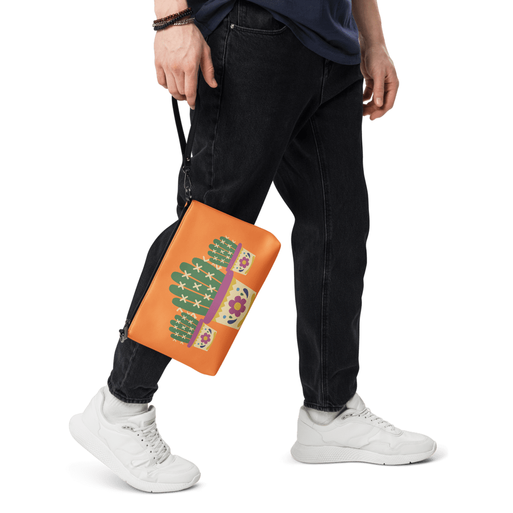 Person holding orange cactus-themed bag.