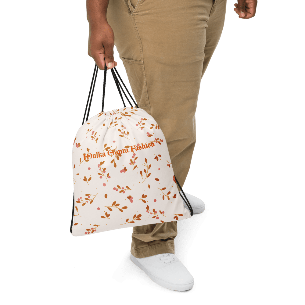 Person holding floral drawstring bag.