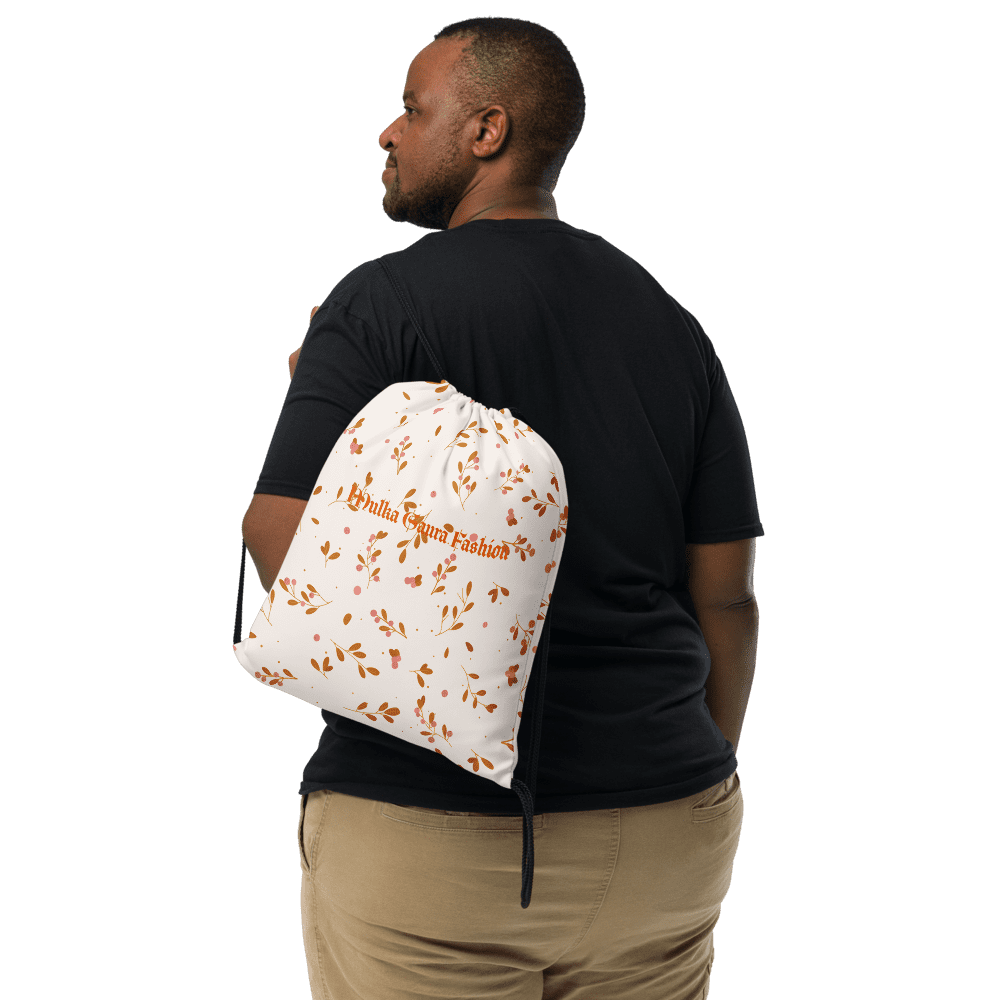 Man with white and orange drawstring bag.
