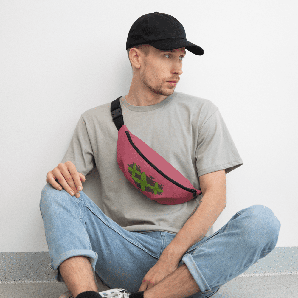 Man sitting casually wearing cap and fanny pack.
