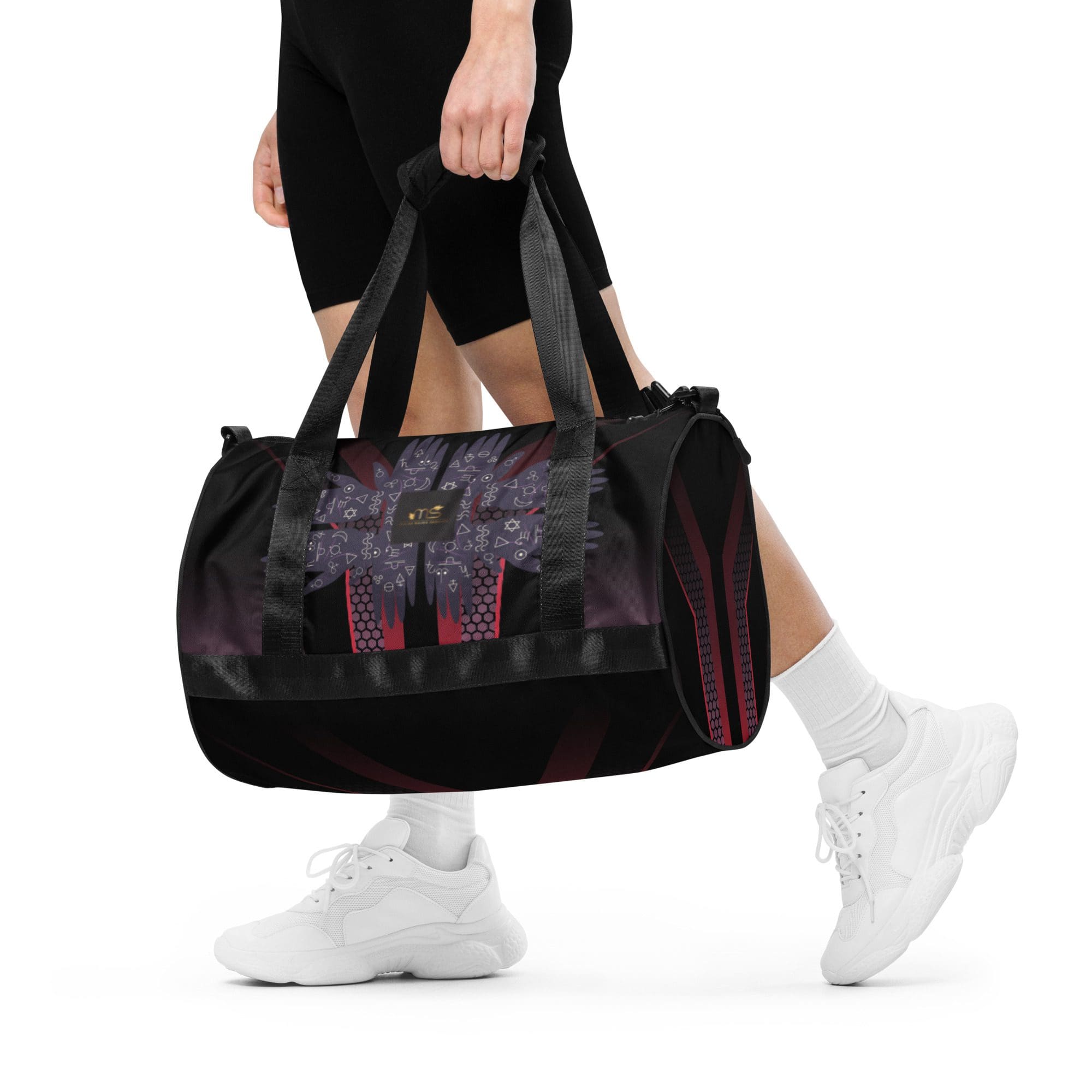 Person carrying a stylish black gym bag.