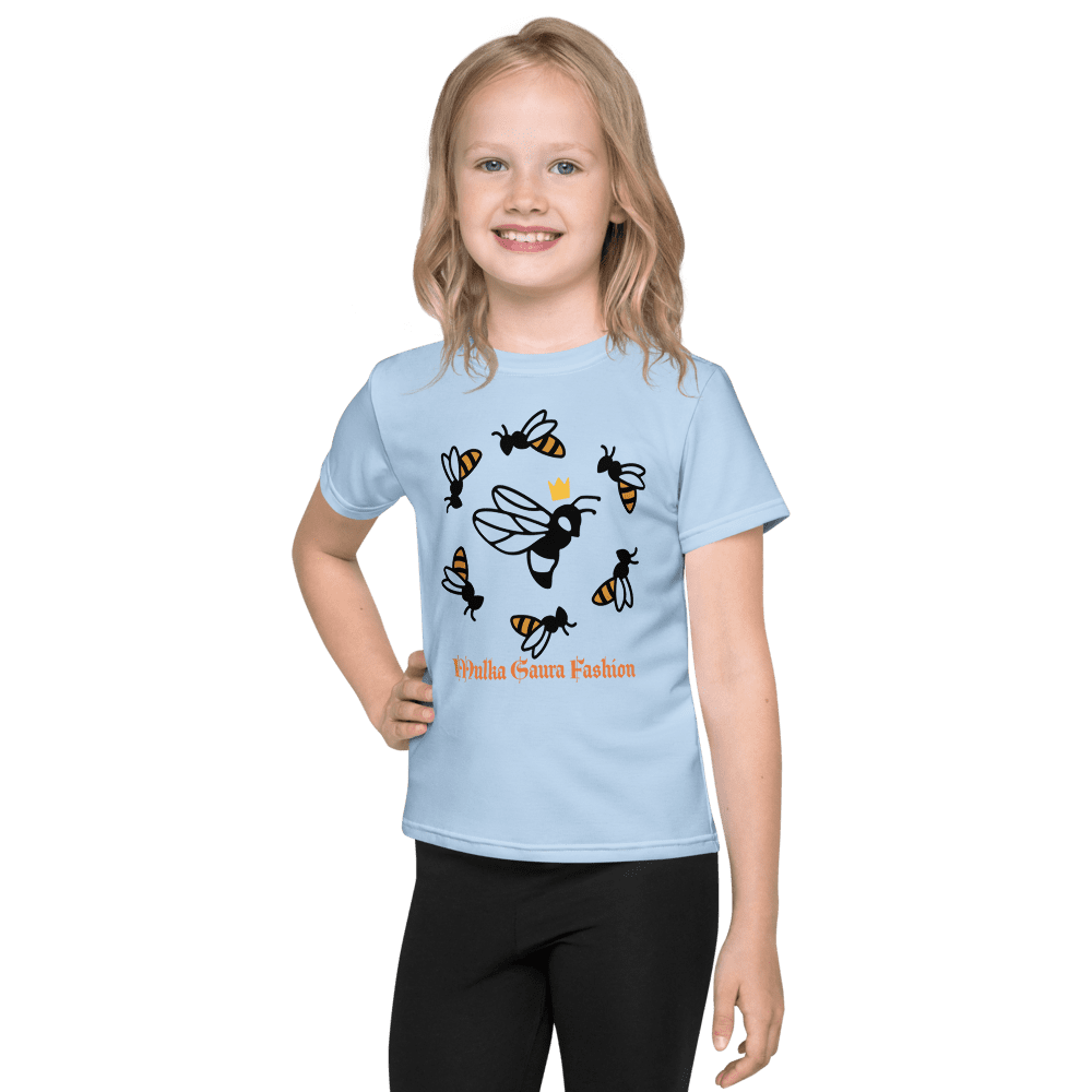 Girl wearing blue bee-themed shirt smiling.