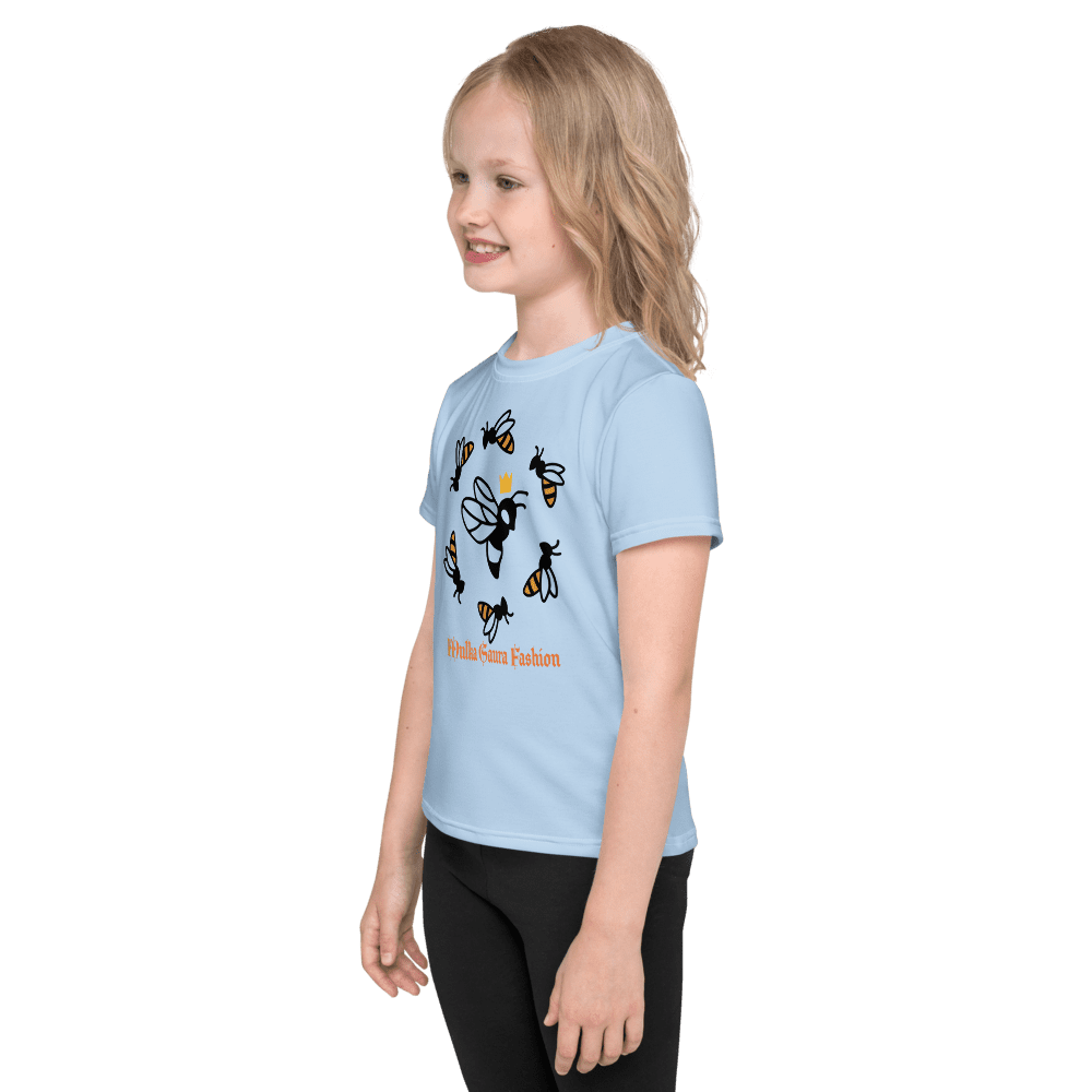 Child wearing blue bee-themed shirt, smiling.