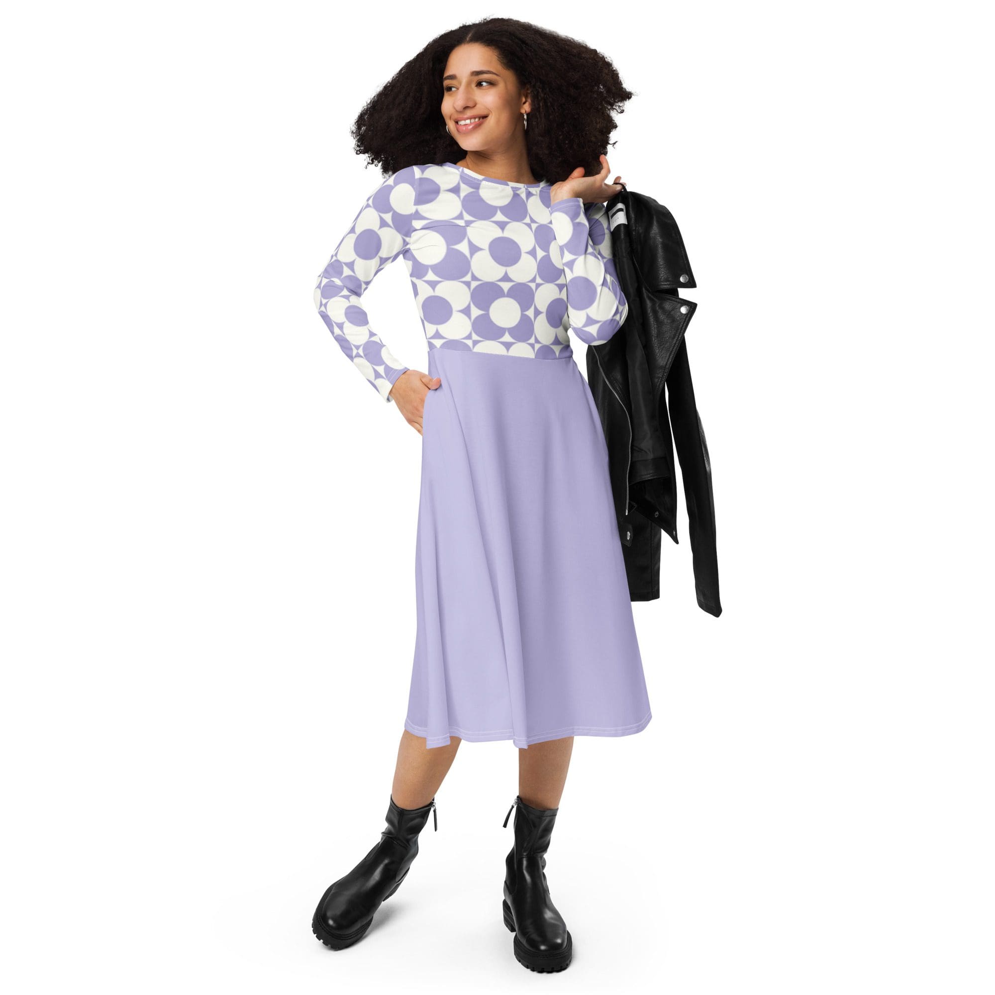 Woman in patterned top and purple skirt.