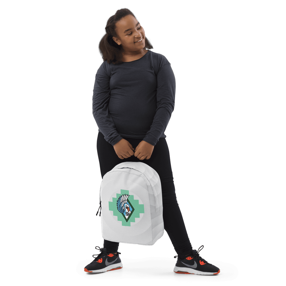 Person holding a white backpack, smiling.