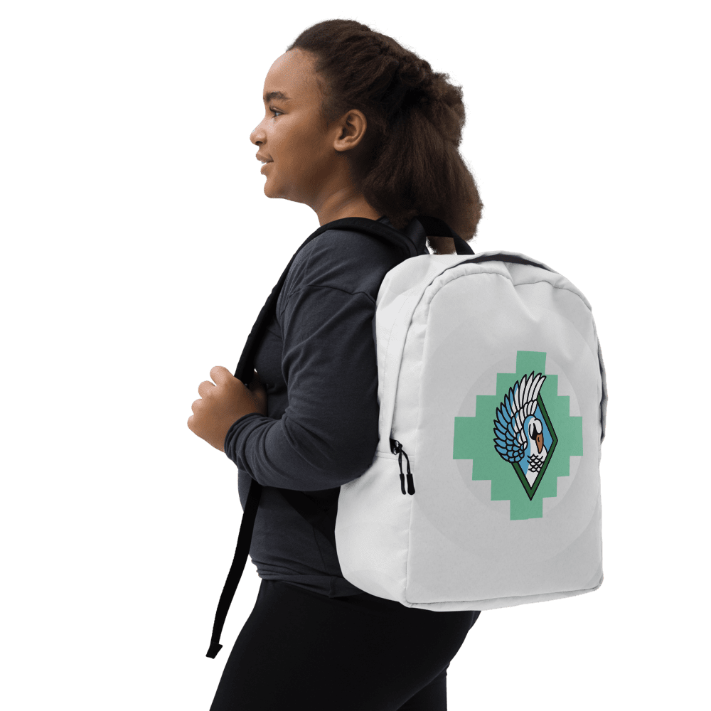 Girl wearing backpack with geometric bird design.