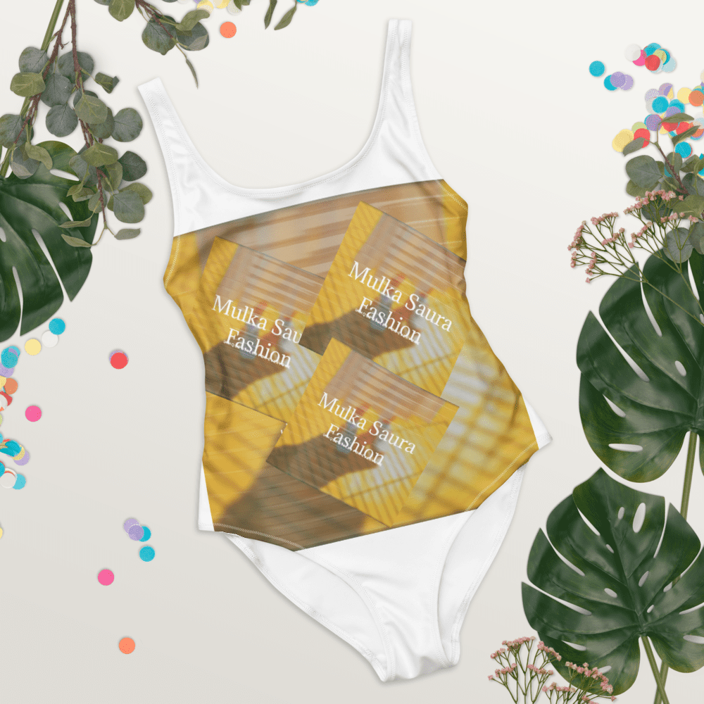 White swimsuit with abstract design and foliage.
