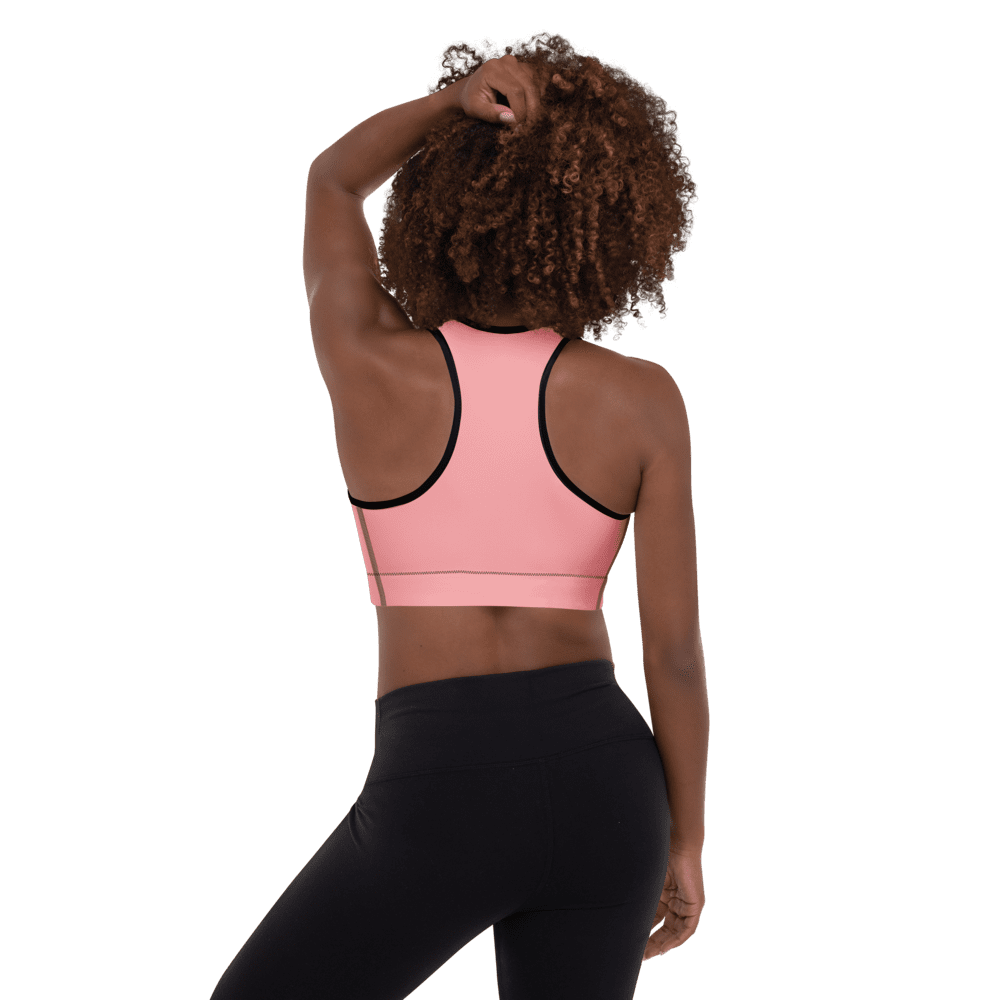 Woman in pink sports bra, black leggings.