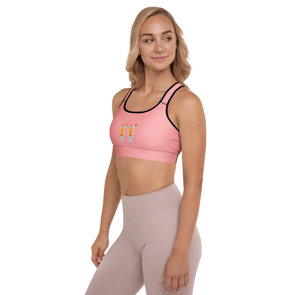 Woman in pink sports bra smiling.