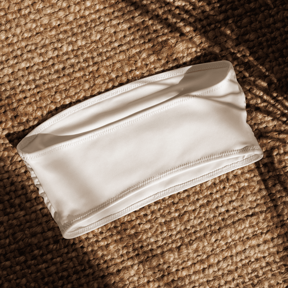 White bandeau top on woven surface.