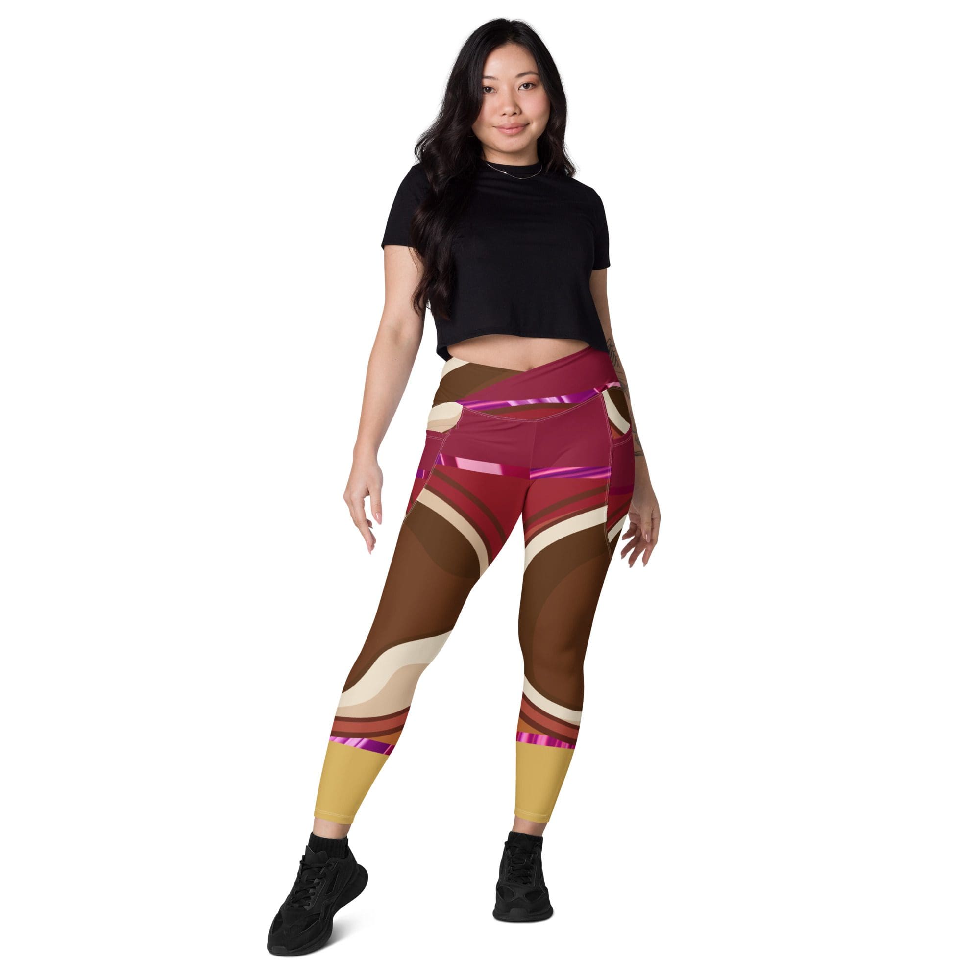 Woman wearing colorful leggings and black top.