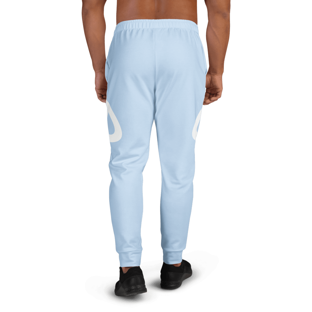 Man wearing light blue track pants, back view.