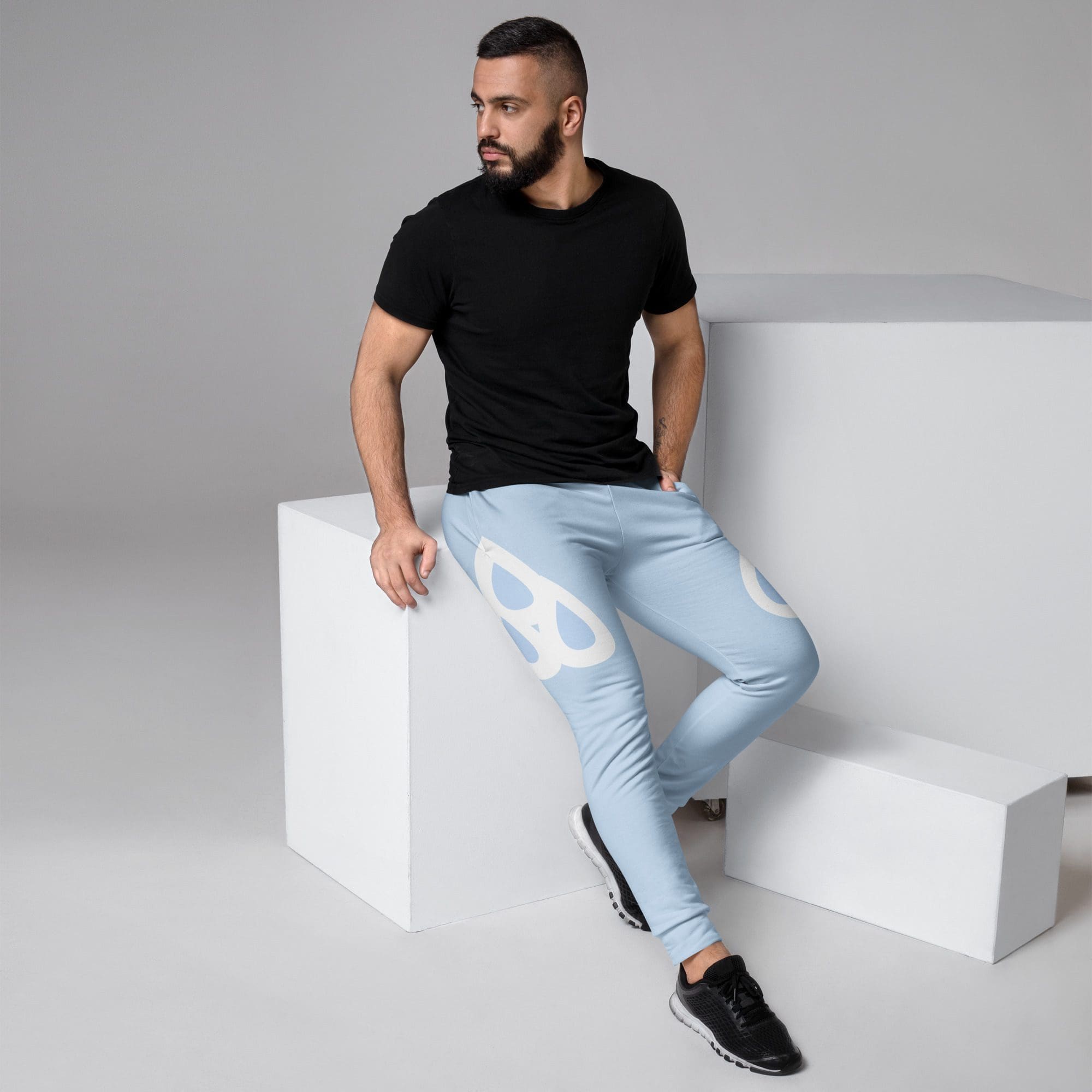Man in skull-patterned pants sitting casually.
