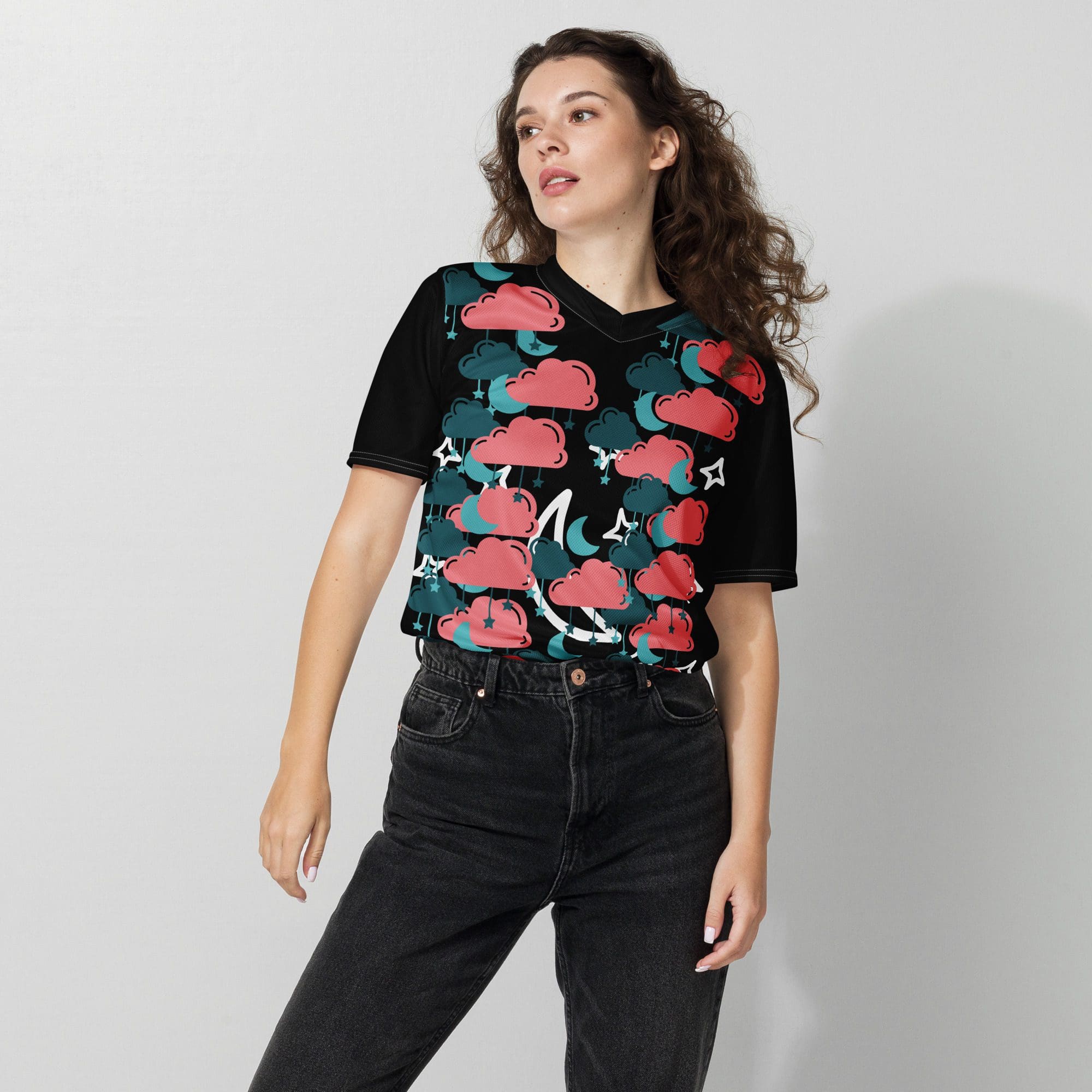 Person wearing colorful cloud-patterned shirt.
