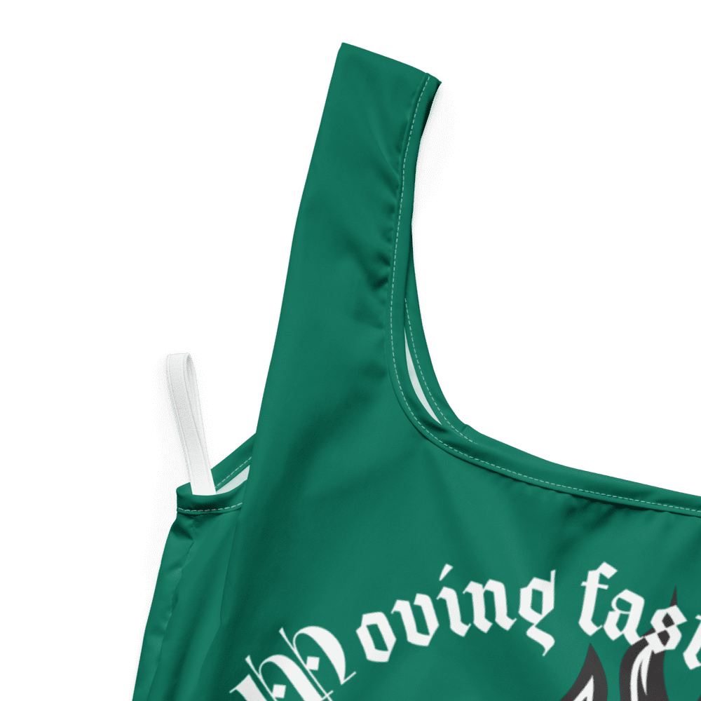 Green garment with partially visible white text.