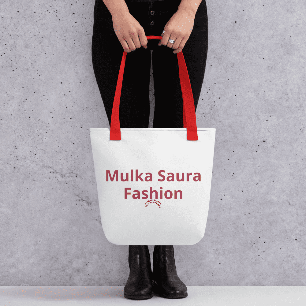 Person holding white tote bag, red handles.