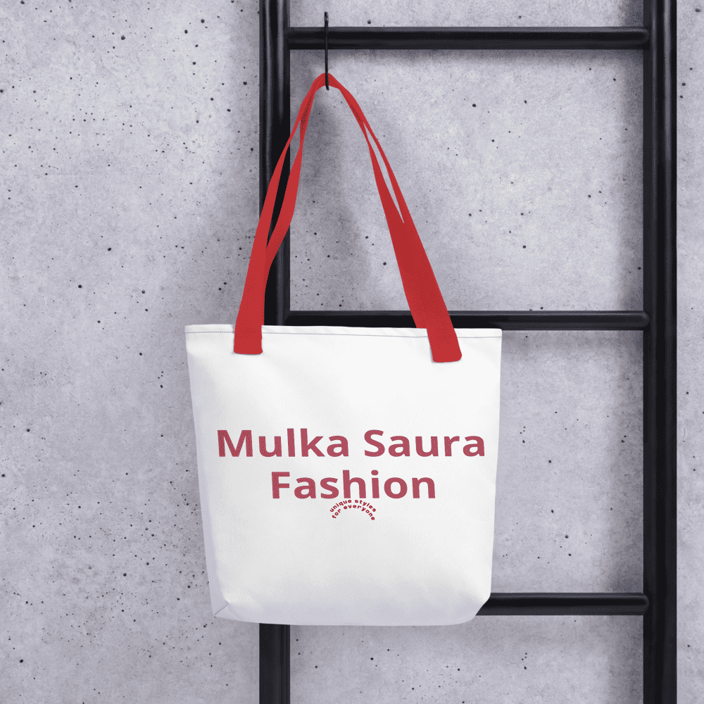 Tote bag with red handles on ladder.