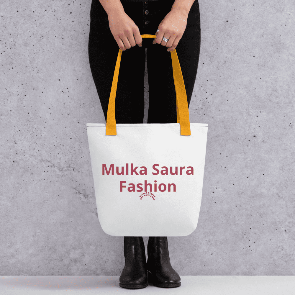 Person holding white tote bag with text.