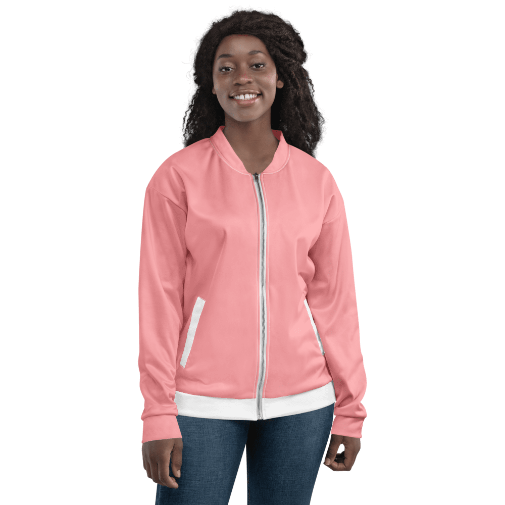 Woman wearing pink jacket, smiling confidently.