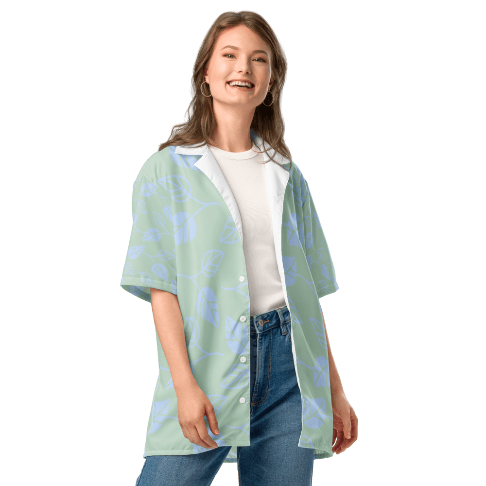 Smiling woman in patterned shirt and jeans.