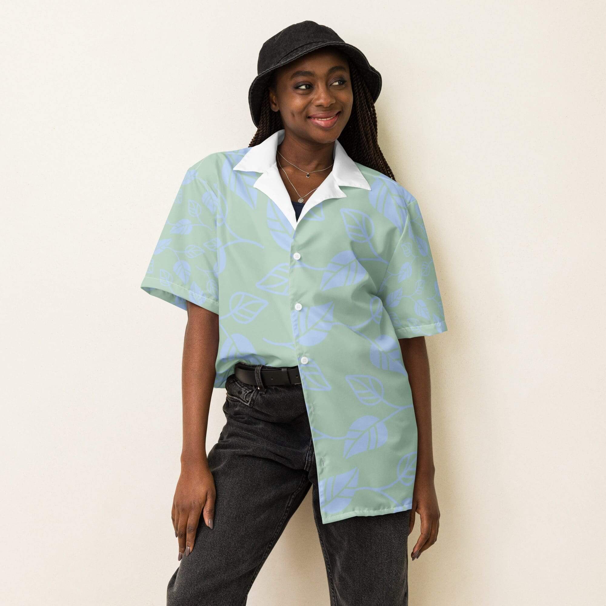 Person wearing patterned shirt and black hat.