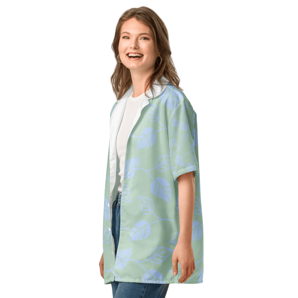 Woman wearing floral green shirt, smiling.